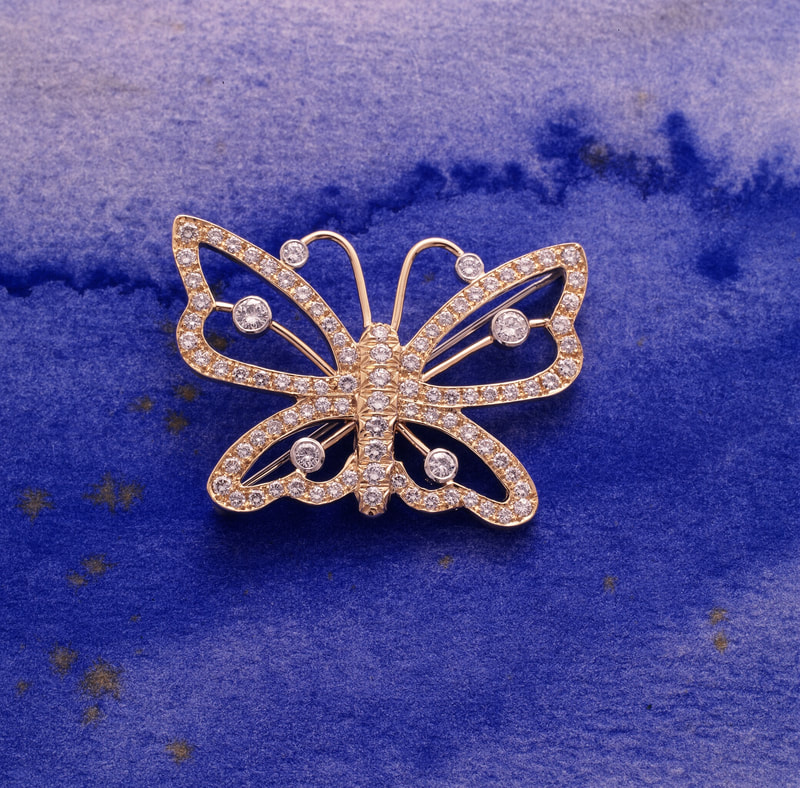 Gold butterfly pin with pave diamonds